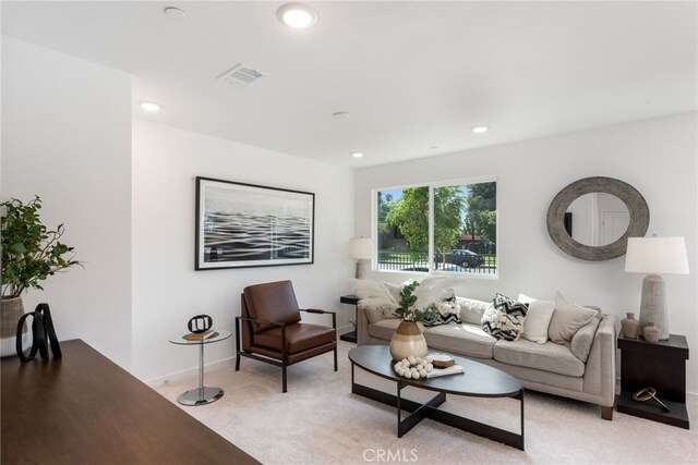 living area with light carpet, baseboards, visible vents, and recessed lighting