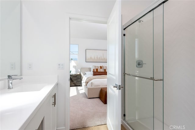 ensuite bathroom featuring a shower stall, vanity, and ensuite bathroom