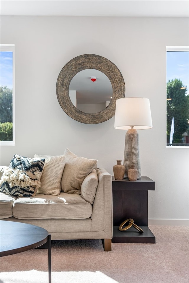 carpeted living room featuring baseboards