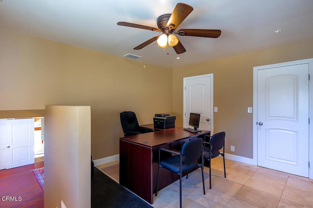 tiled office space with ceiling fan