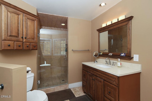 bathroom featuring tile patterned flooring, toilet, vanity, and an enclosed shower