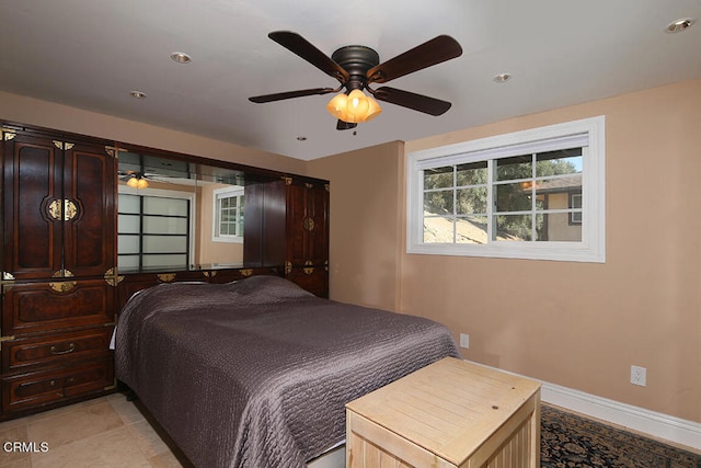 tiled bedroom with ceiling fan