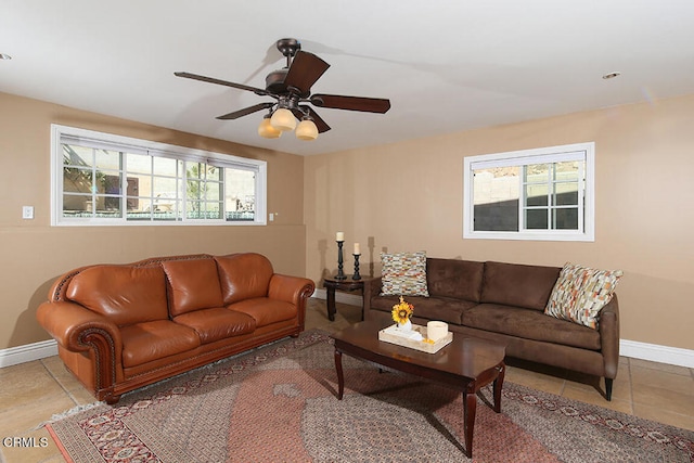 living room featuring ceiling fan, plenty of natural light, and light tile patterned floors