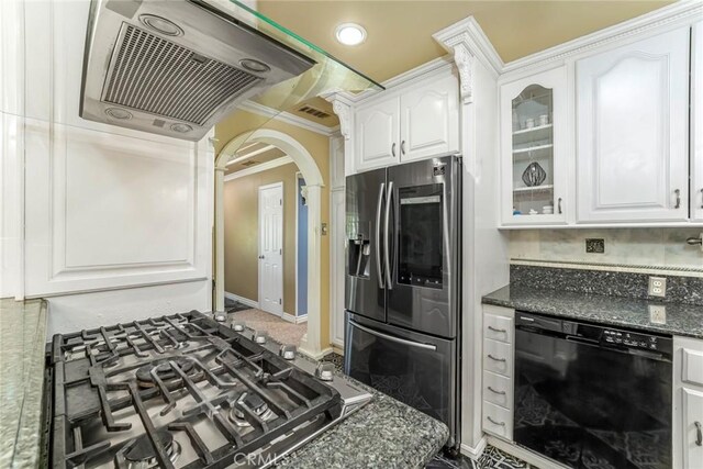 kitchen with white cabinetry, appliances with stainless steel finishes, crown molding, dark stone countertops, and tasteful backsplash