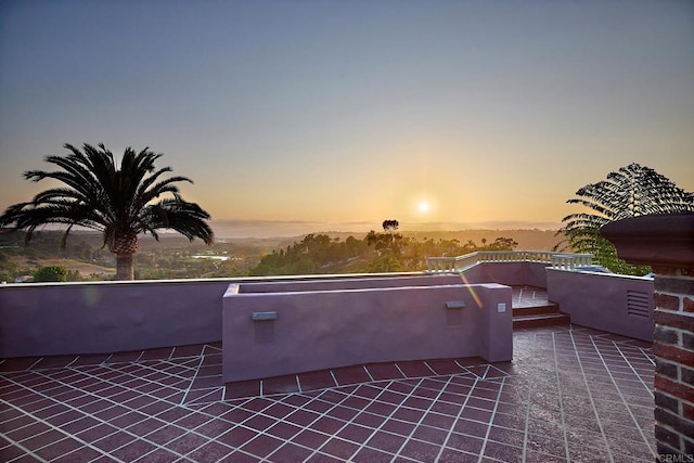 view of patio terrace at dusk