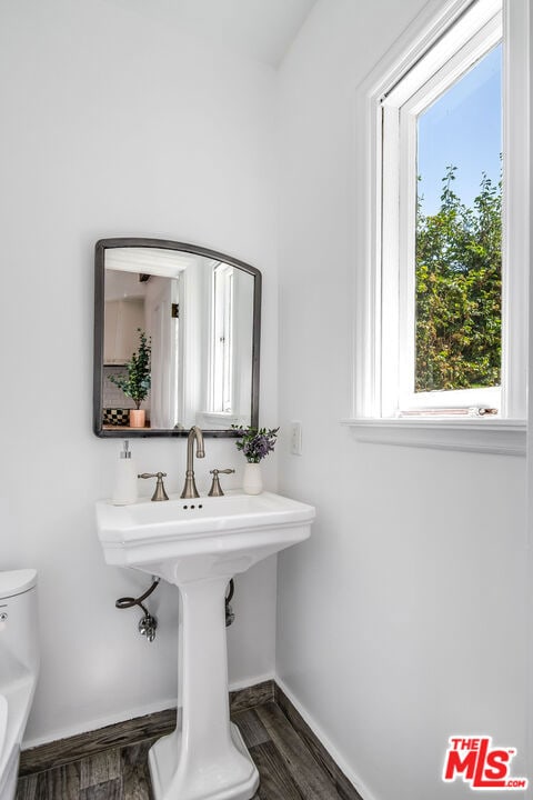 bathroom featuring hardwood / wood-style flooring, plenty of natural light, and toilet