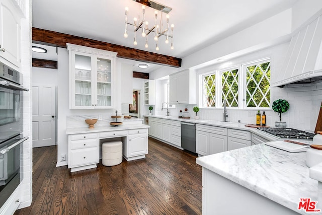 kitchen featuring decorative light fixtures, white cabinetry, appliances with stainless steel finishes, and beamed ceiling