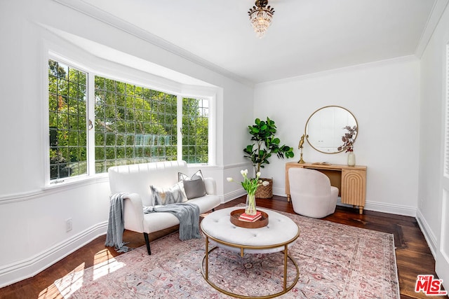 living area featuring crown molding and hardwood / wood-style floors