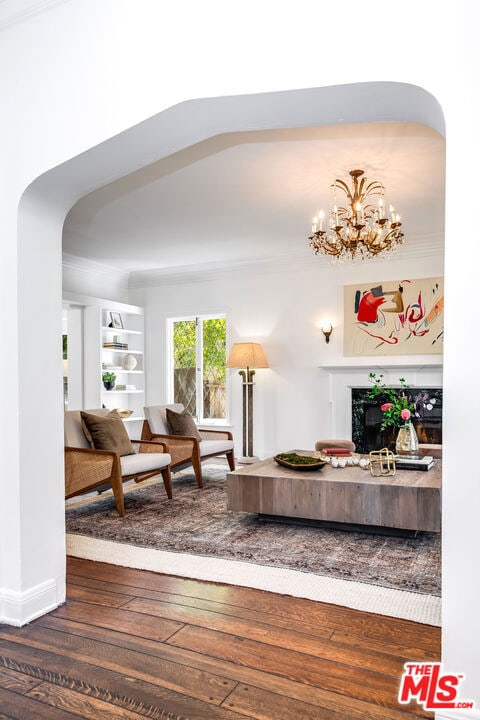 living room with dark hardwood / wood-style flooring and a notable chandelier