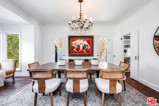 dining space with dark wood-type flooring, an inviting chandelier, and ornamental molding