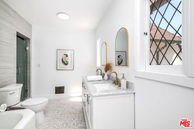 bathroom featuring toilet, vanity, and tile patterned flooring