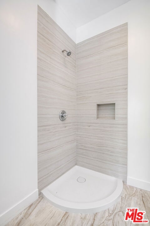 bathroom with tiled shower