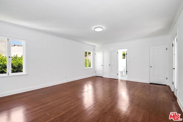 unfurnished room with dark hardwood / wood-style floors and crown molding