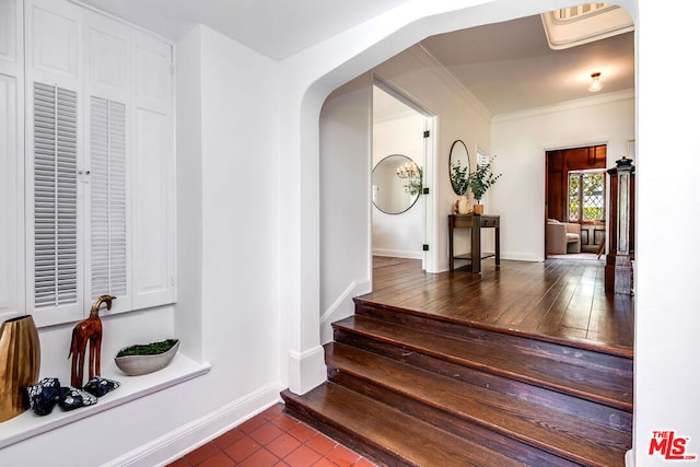 interior space featuring tile patterned flooring and crown molding