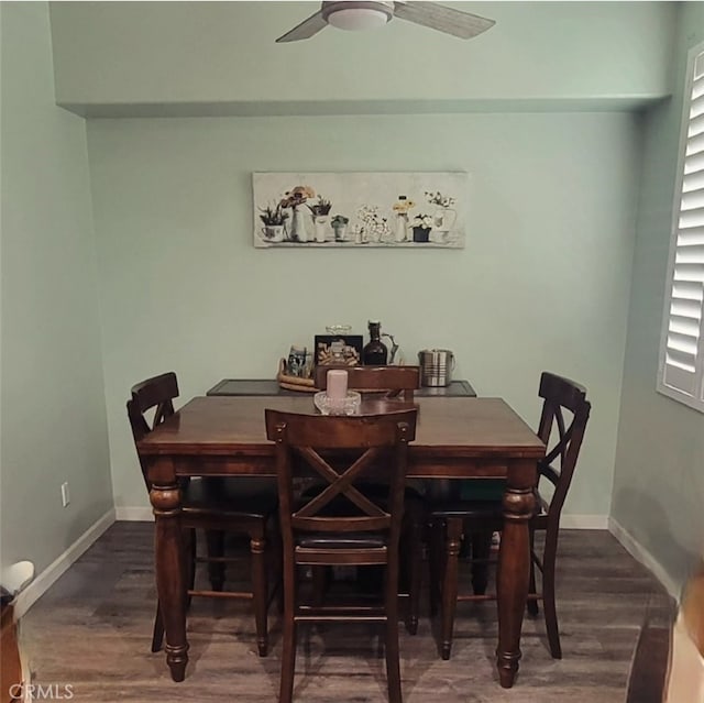 dining area with ceiling fan and dark hardwood / wood-style floors