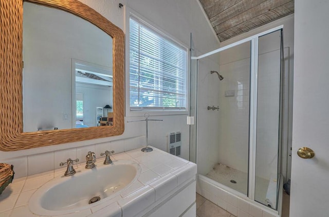 bathroom featuring walk in shower, vanity, and tile patterned flooring