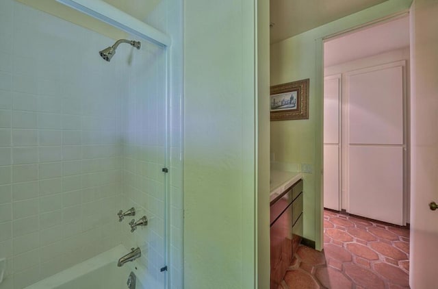 bathroom featuring tiled shower / bath combo and vanity