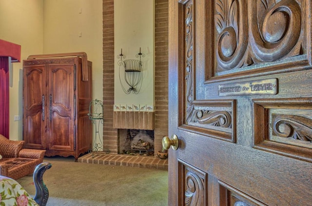 living room with carpet and a brick fireplace