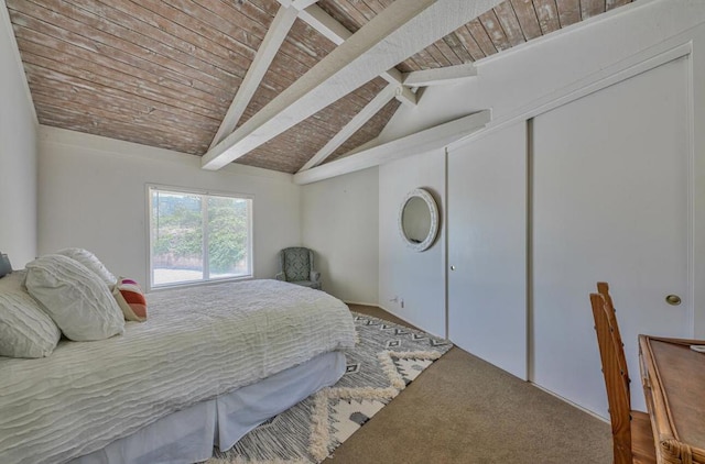 carpeted bedroom featuring ceiling fan, vaulted ceiling with beams, and wood ceiling