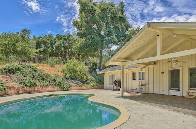 view of swimming pool with ceiling fan and a patio