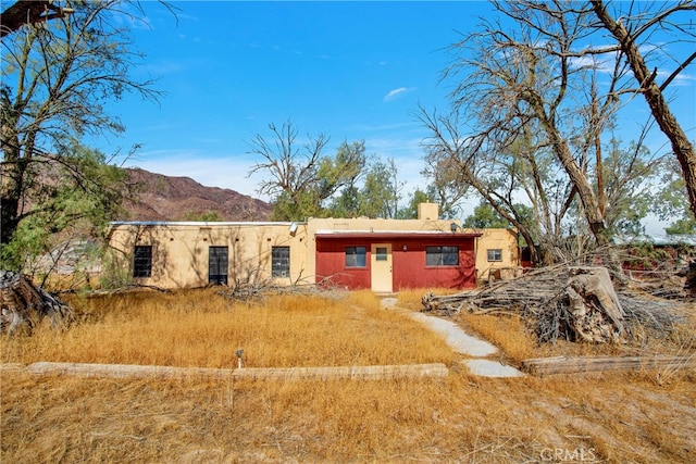 back of house featuring a mountain view