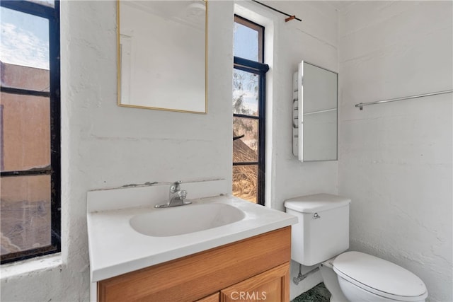 bathroom featuring toilet and vanity