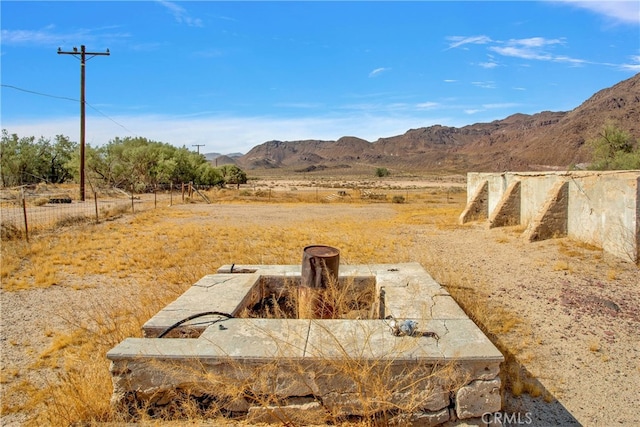 view of yard with a rural view and a mountain view