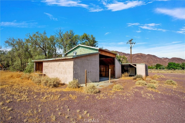 view of outbuilding with a mountain view