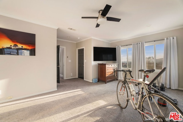 interior space with ceiling fan, ornamental molding, and light carpet