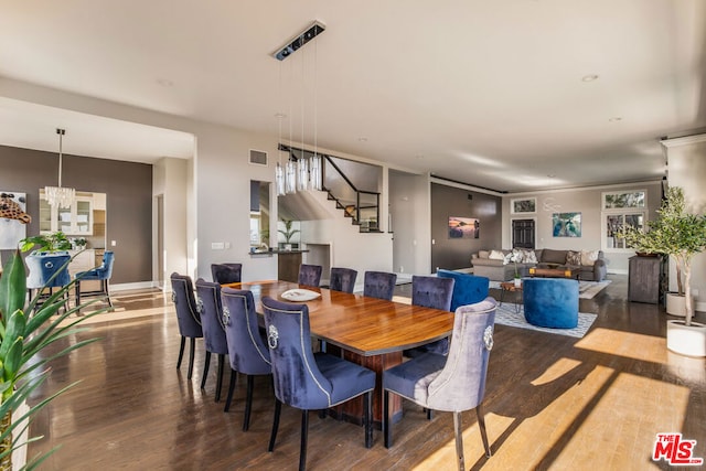 dining room with a notable chandelier and dark wood-type flooring