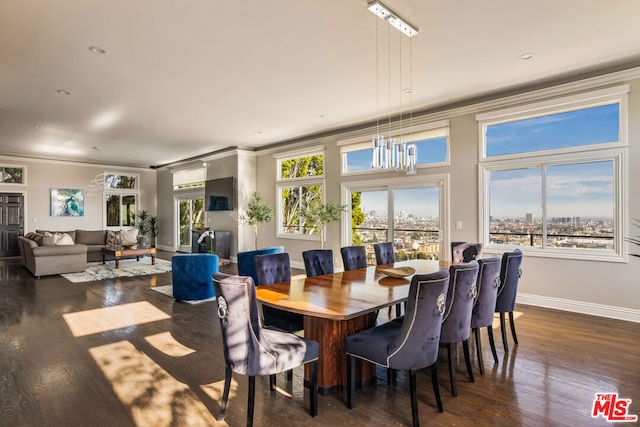 dining room featuring a notable chandelier, dark wood-type flooring, and ornamental molding