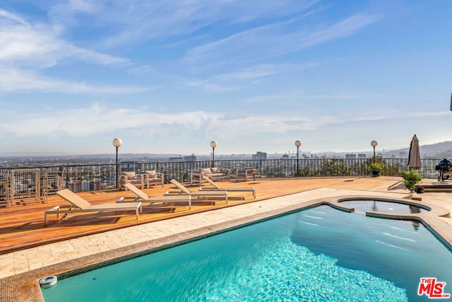 view of pool with a patio area and a deck