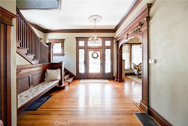 455 W 20th St, Merced, CA 95340 - foyer entrance with a notable chandelier, crown molding, and light hardwood / wood-style flooring