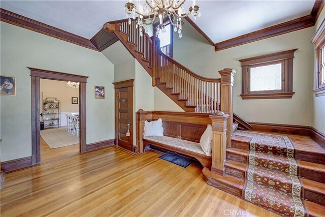455 W 20th St, Merced, CA 95340 - staircase featuring hardwood / wood-style flooring, crown molding, and a chandelier