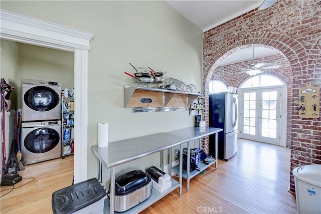 455 W 20th St, Merced, CA 95340 - interior space featuring stainless steel refrigerator, stacked washer and dryer, brick wall, and french doors
