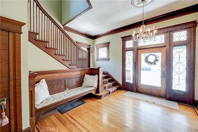 455 W 20th St, Merced, CA 95340 - foyer with ornamental molding, a chandelier, and light wood-type flooring