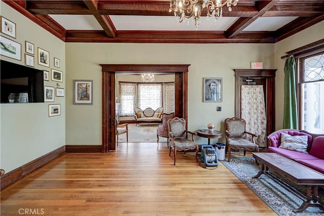 455 W 20th St, Merced, CA 95340 - living room featuring an inviting chandelier, coffered ceiling, a healthy amount of sunlight, and light wood-type flooring