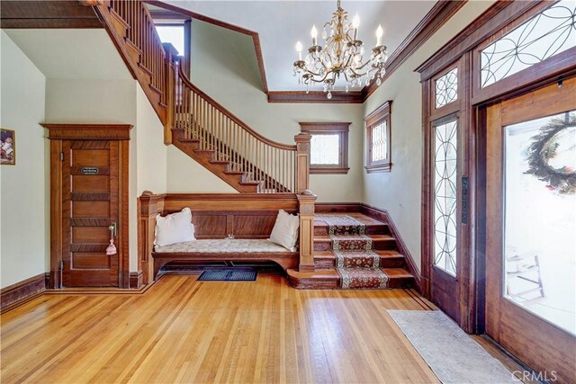 455 W 20th St, Merced, CA 95340 - entryway featuring crown molding, a chandelier, and light hardwood / wood-style flooring
