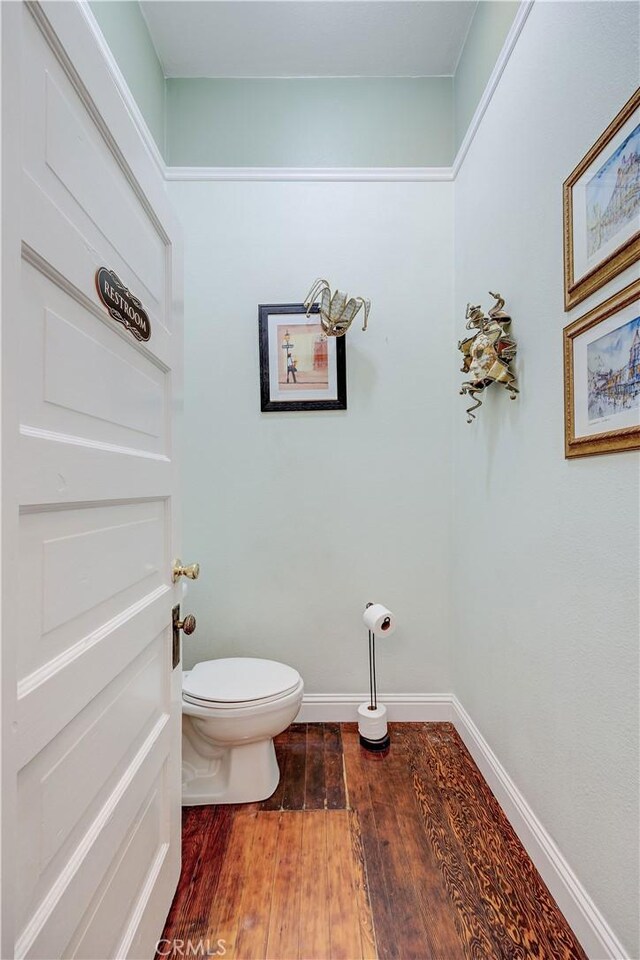 455 W 20th St, Merced, CA 95340 - bathroom featuring wood-type flooring and toilet