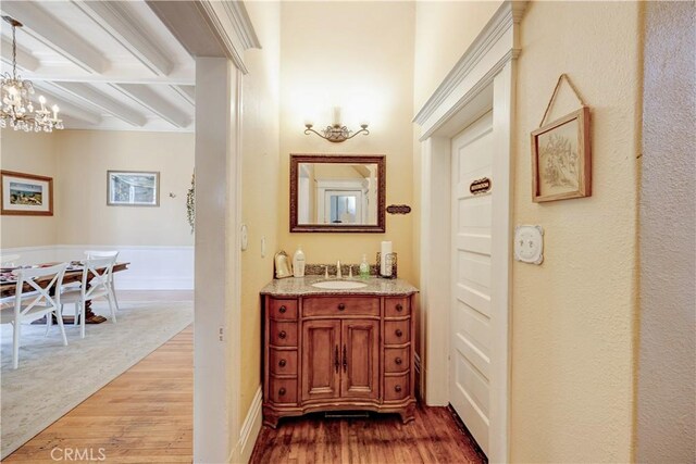 455 W 20th St, Merced, CA 95340 - bathroom featuring hardwood / wood-style flooring, vanity, and a chandelier