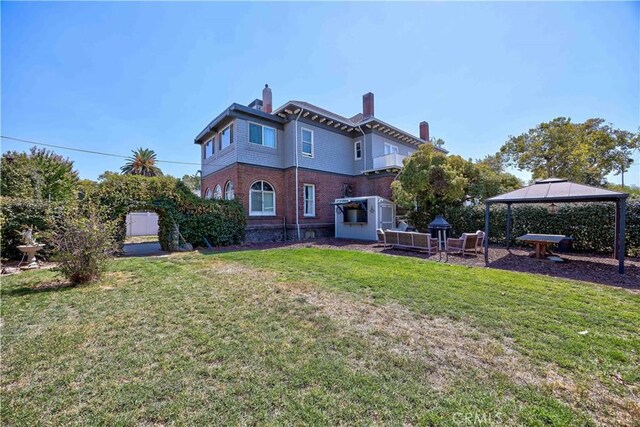455 W 20th St, Merced, CA 95340 - rear view of property featuring a gazebo, a storage shed, and a lawn