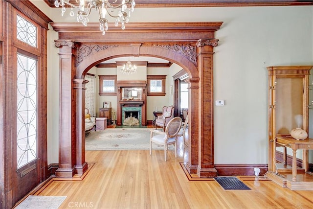 455 W 20th St, Merced, CA 95340 - foyer with an inviting chandelier, ornamental molding, and light hardwood / wood-style flooring
