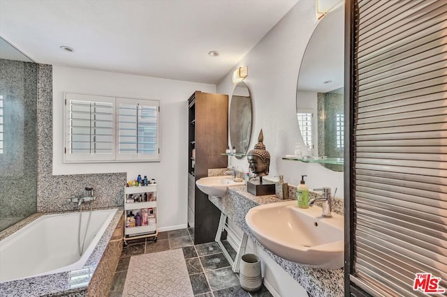 bathroom with vanity and a relaxing tiled tub