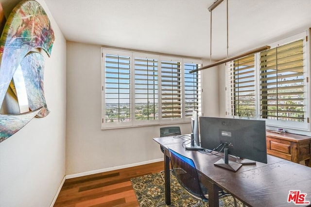 office area with plenty of natural light and dark wood-type flooring