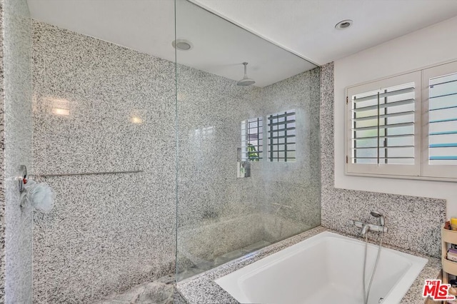 bathroom featuring separate shower and tub