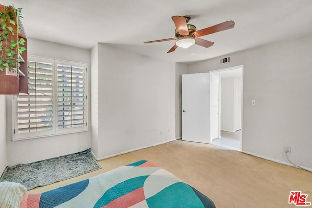 interior space with light carpet and ceiling fan