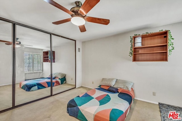 bedroom featuring light carpet, a closet, and ceiling fan