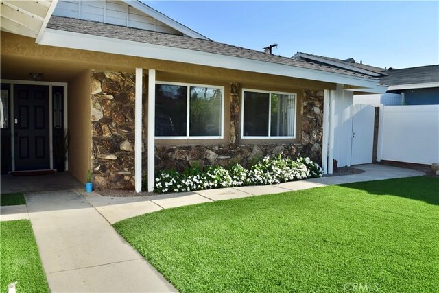 entrance to property with a lawn