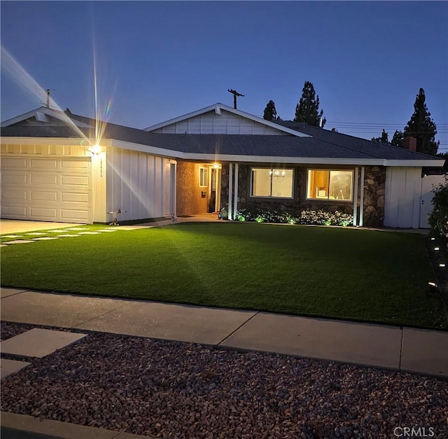 ranch-style home with a lawn and a garage