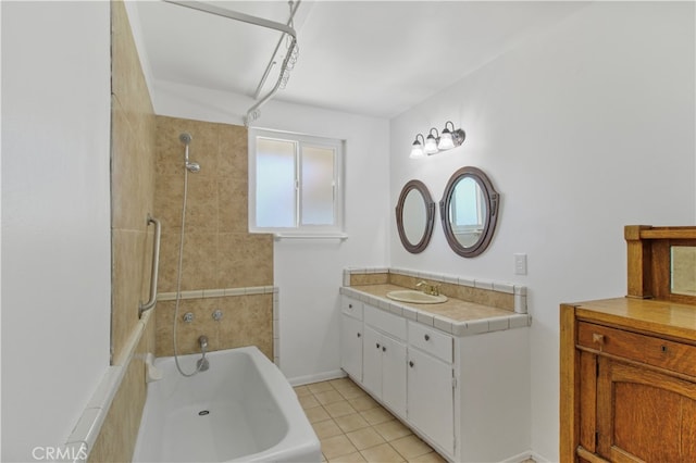 bathroom with tile patterned floors, vanity, and tiled shower / bath combo